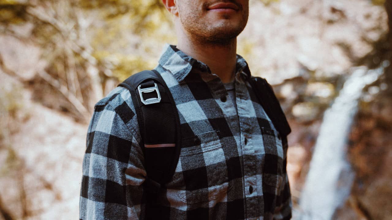 Man wears flannel hiking shirt