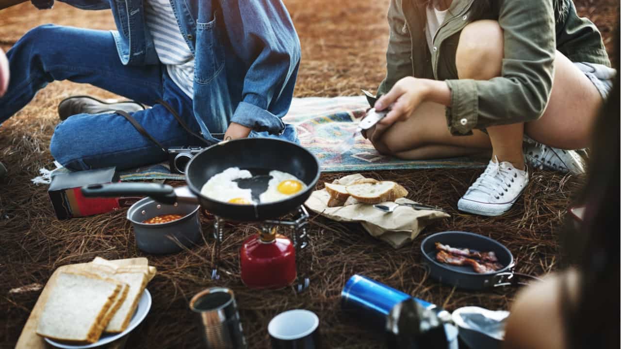 People using a backpacking stove