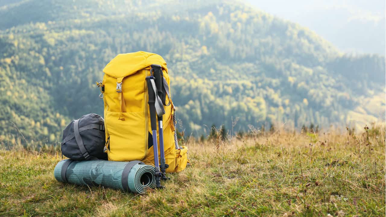 Hiking poles next to a backpack
