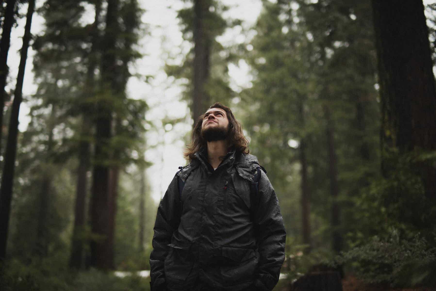man standing in the forest in the rain