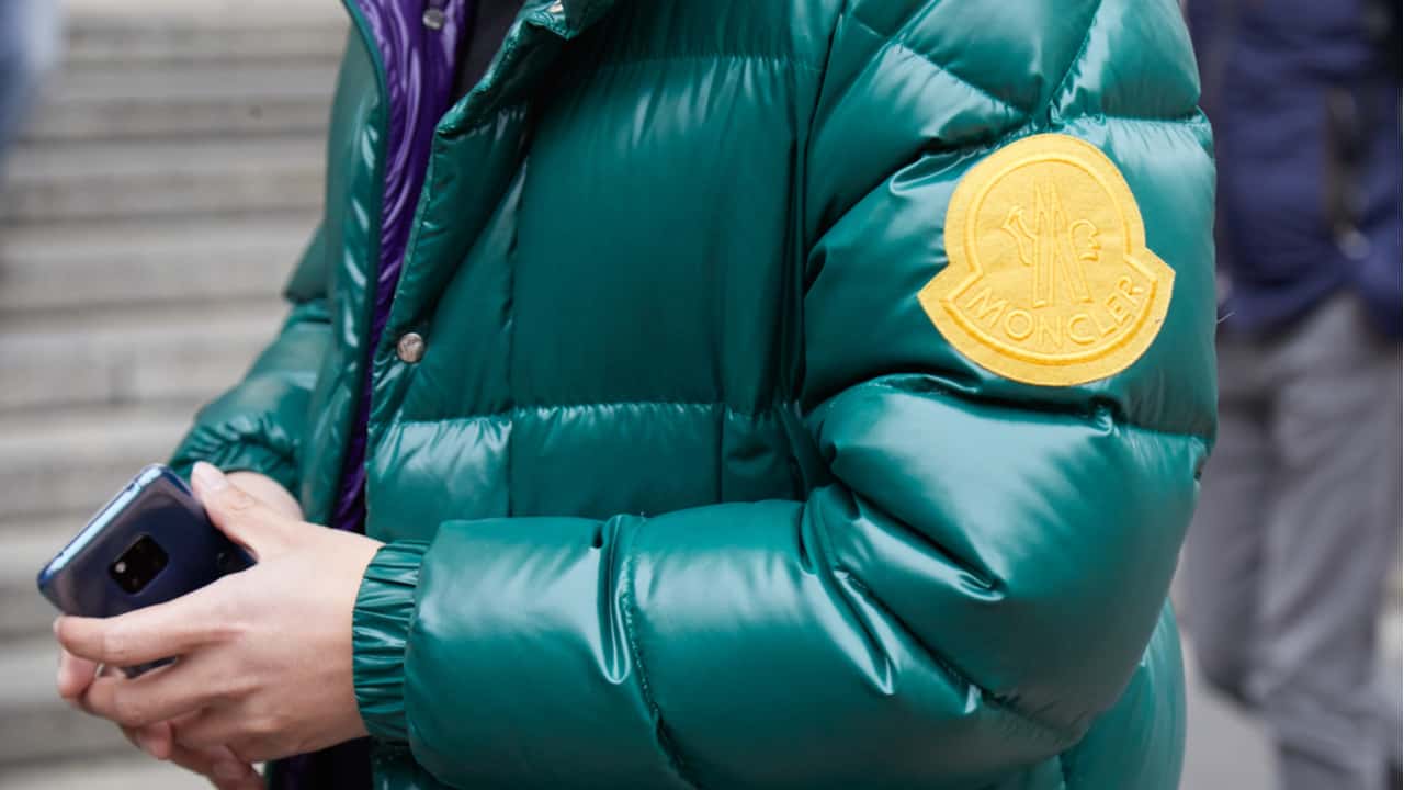 Man in a green Moncler jacket
