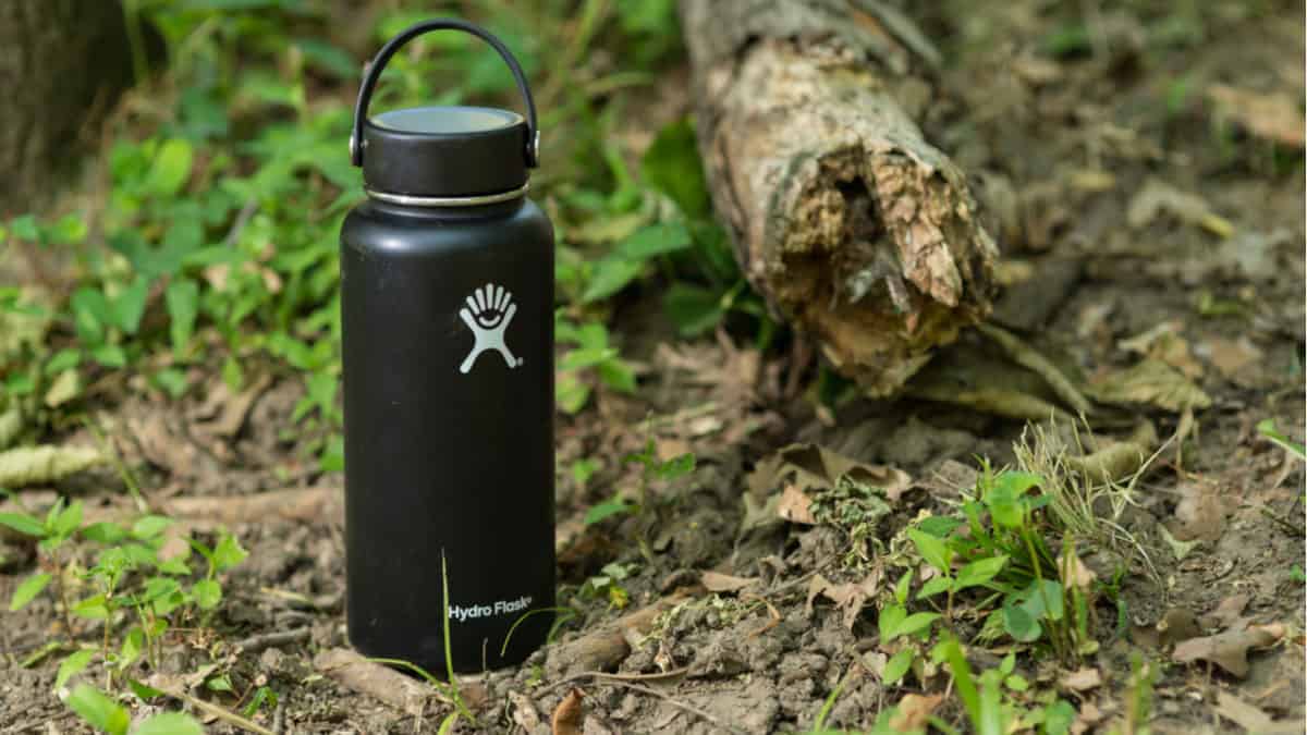 Black Hydro Flask in the woods