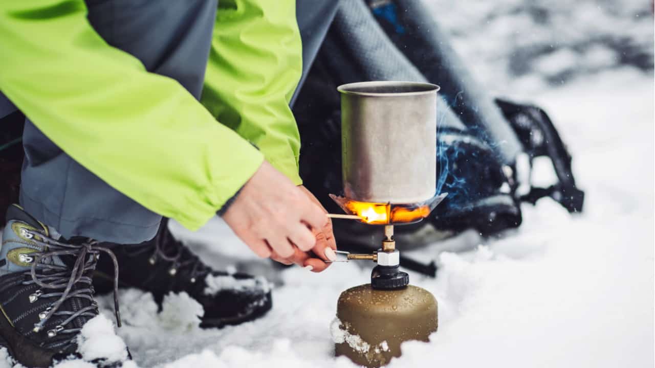 Hiker using a camping stove