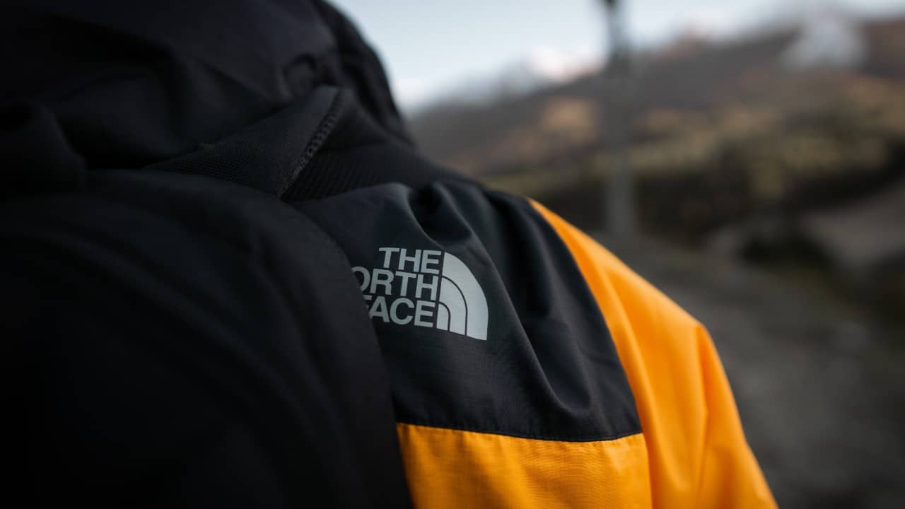 Person wears a North Face rain jacket