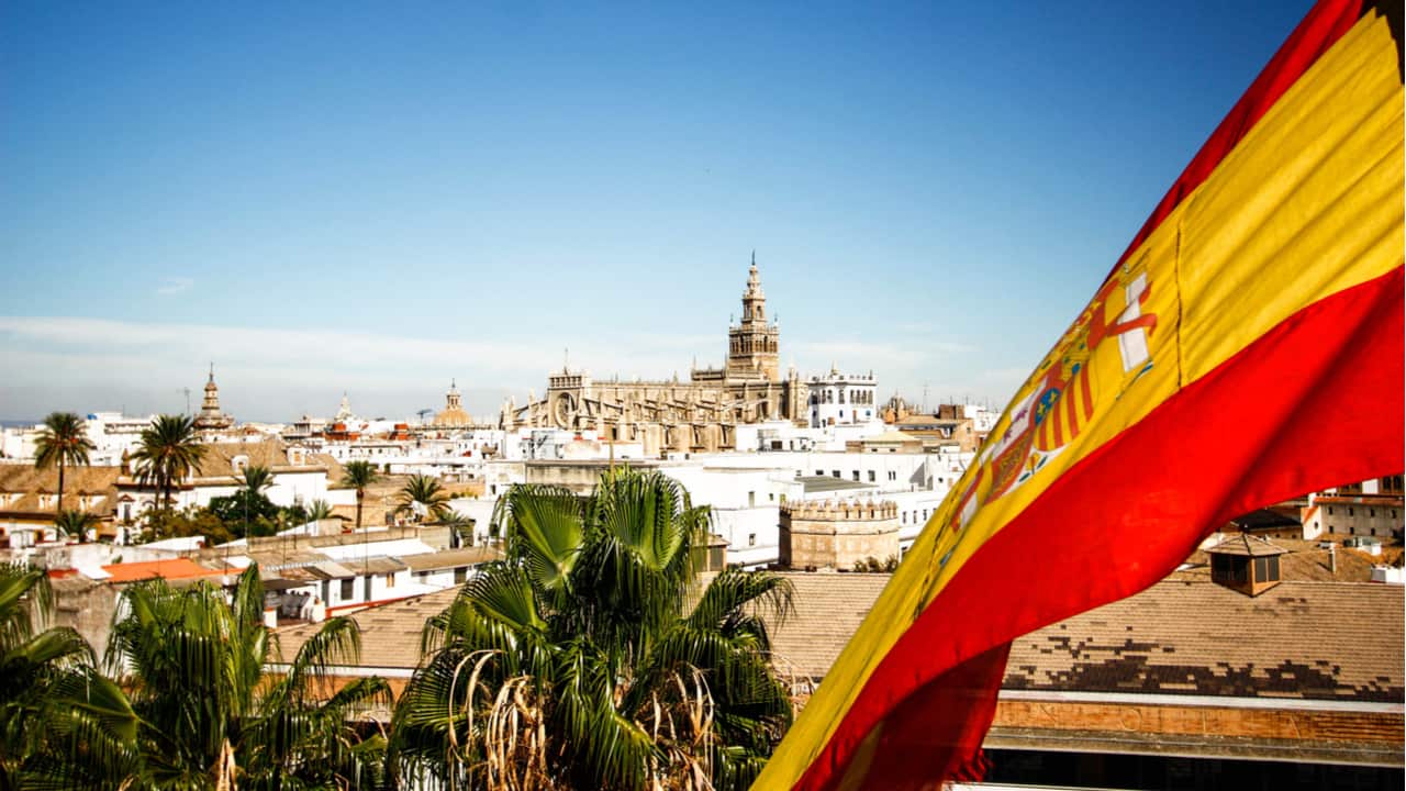 Spanish flag with Seville in the background