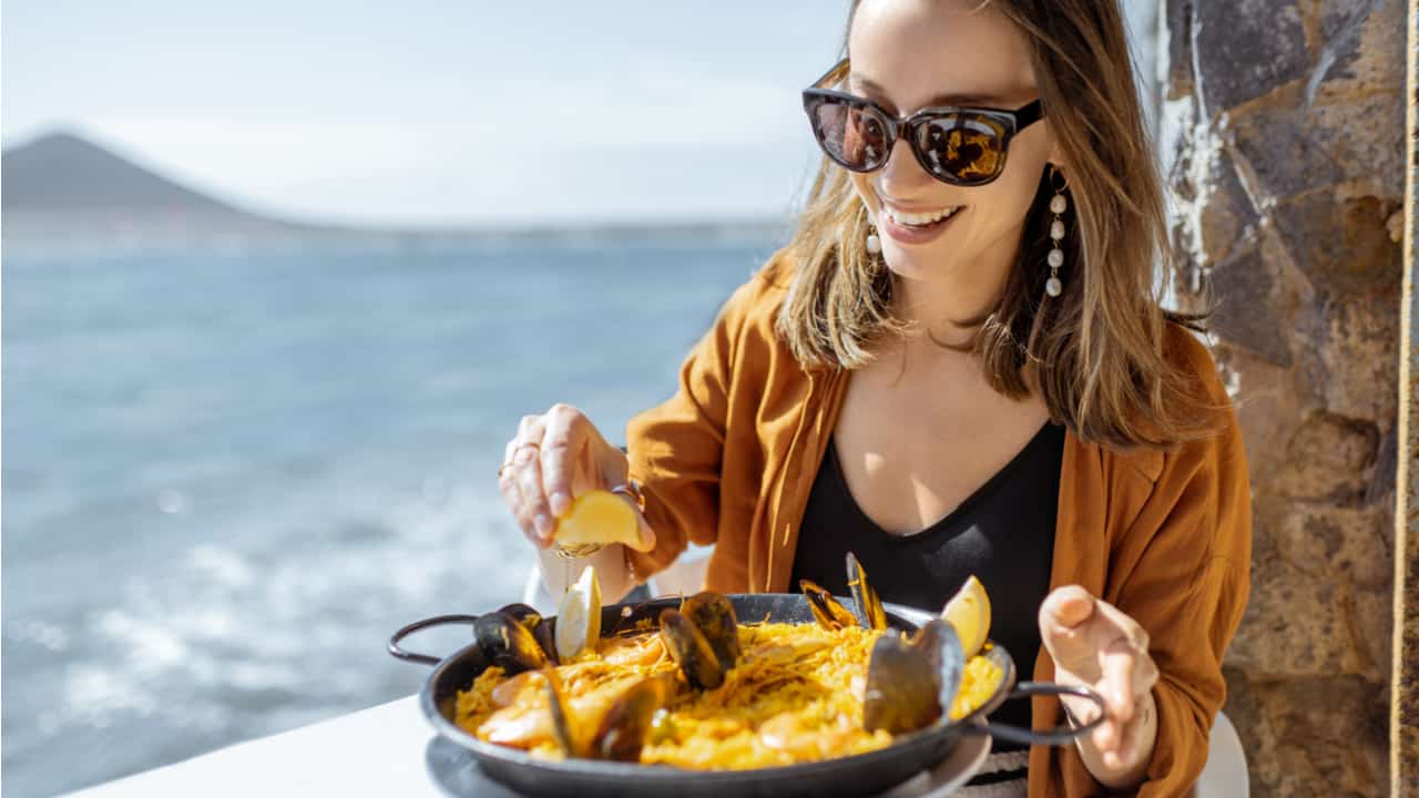 Woman eating paella