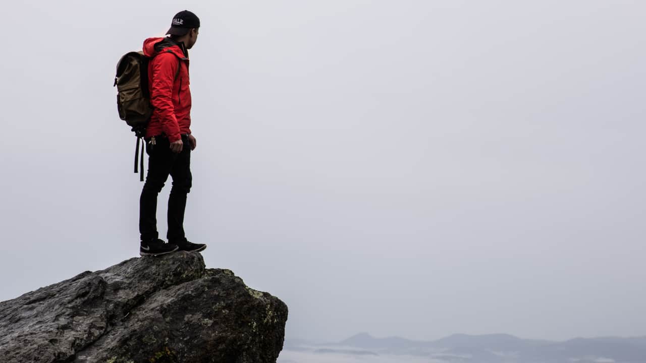 Hiker stands in softshell pants