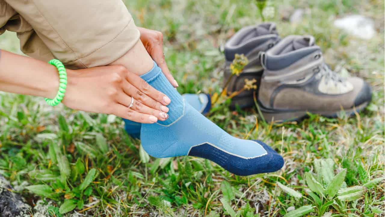 Woman puts on hiking socks