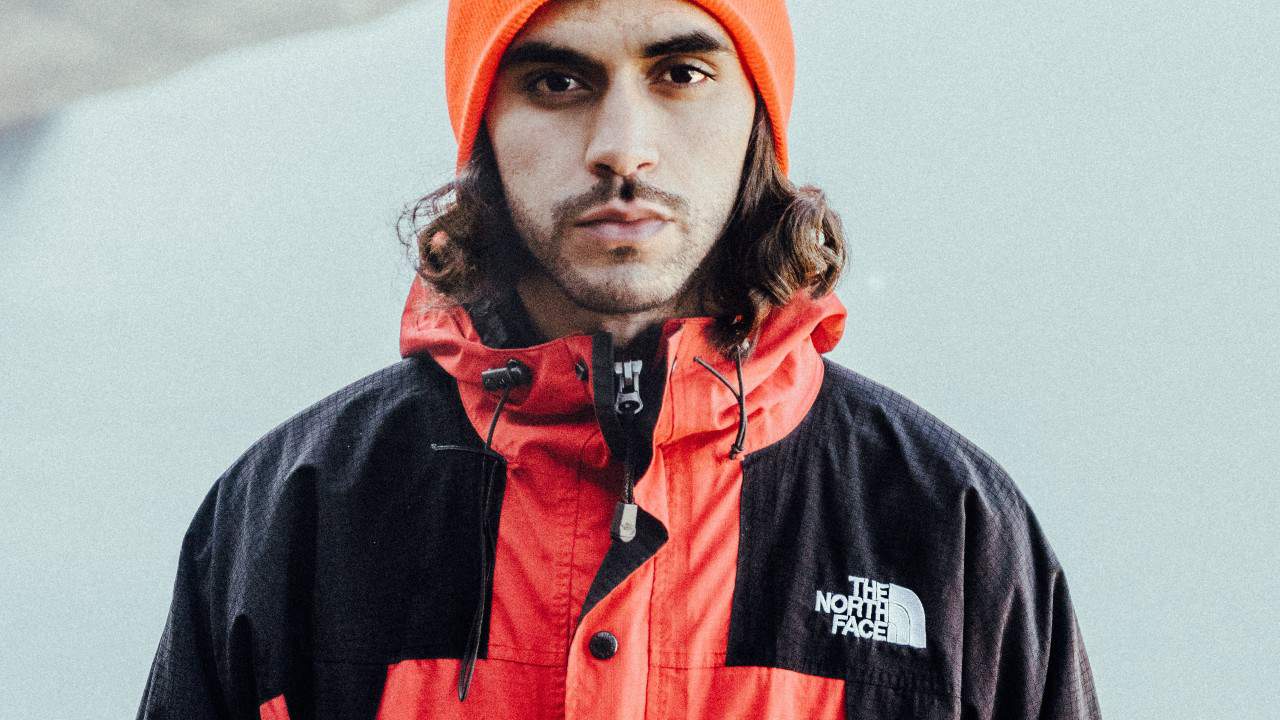 Man wears red North Face jacket