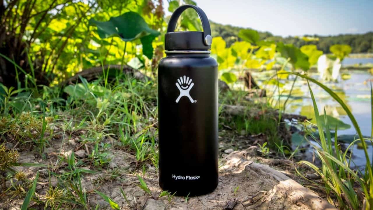 Black Hydro Flask on a Shore