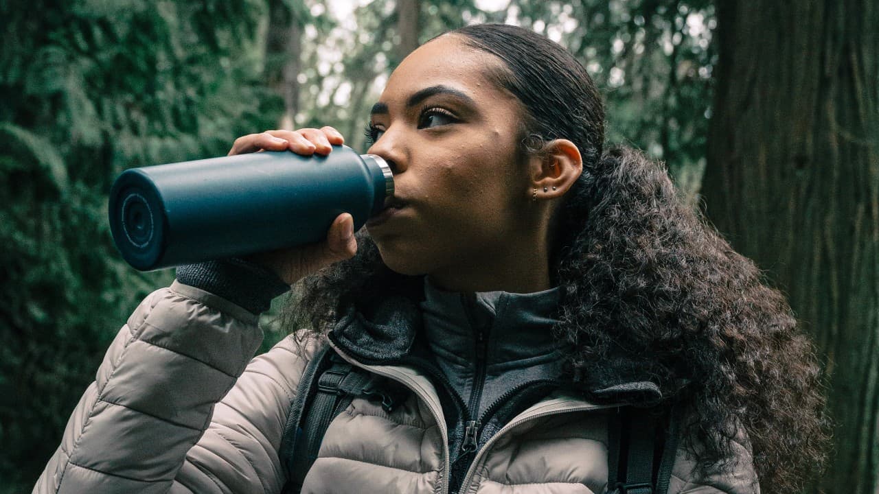 Young hiker drinking water