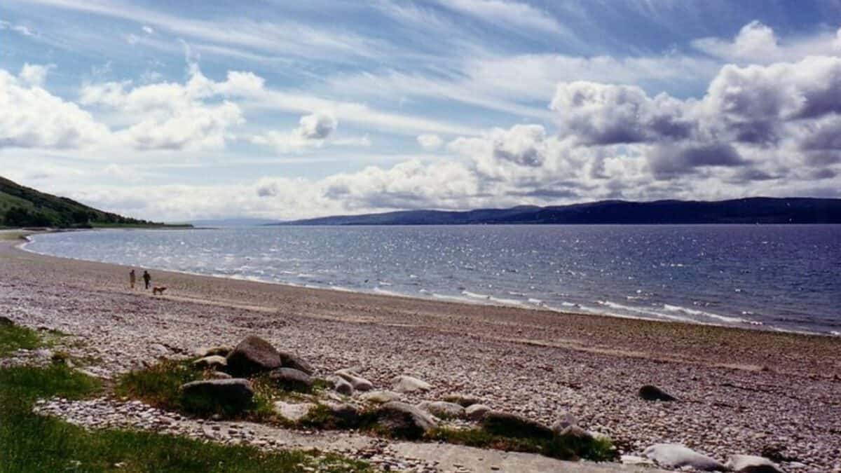 Couple strolling along Dougarie Beach on the Isle of Arran