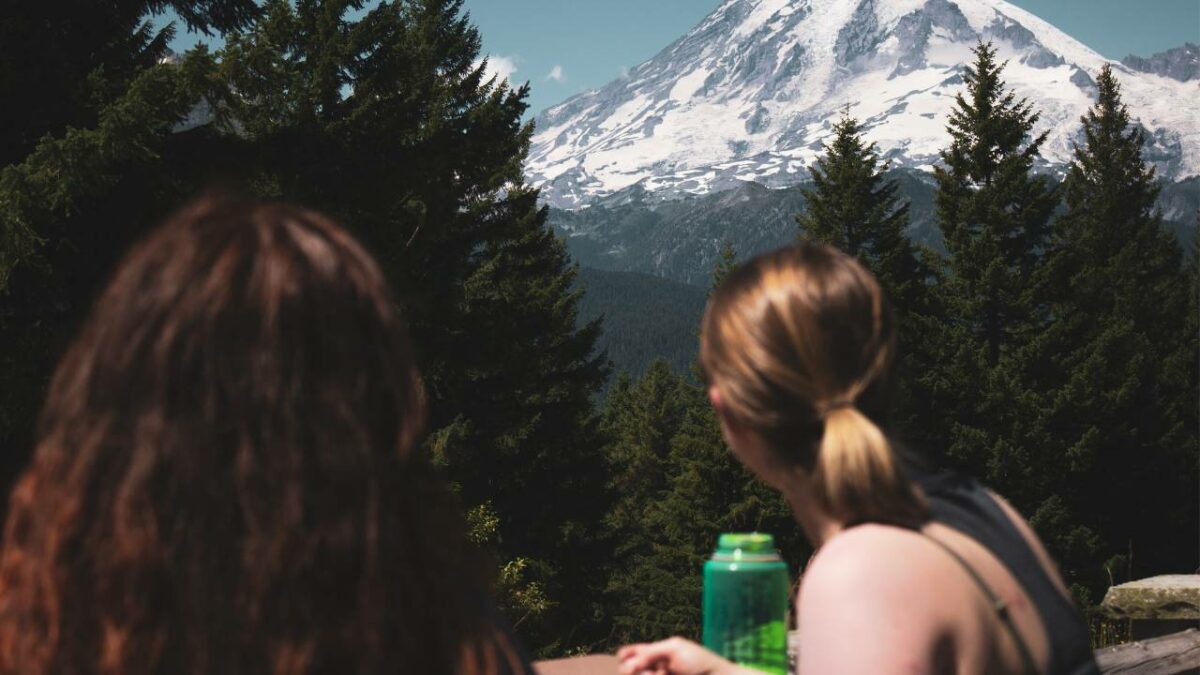 Two female campers looking at Mt Rainier