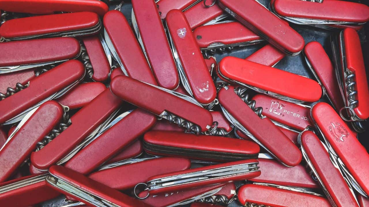 A bunch of Swiss army knives on a table