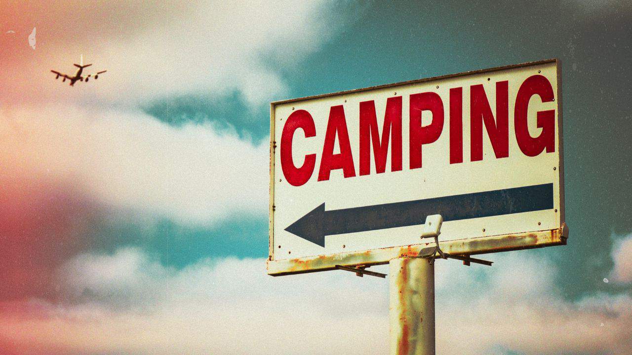 Camping sign with sky in the background