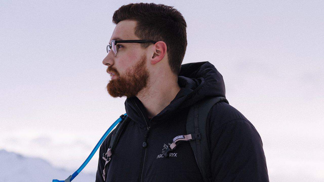 A bearded man with glasses wearing an Arc'teryx jacket