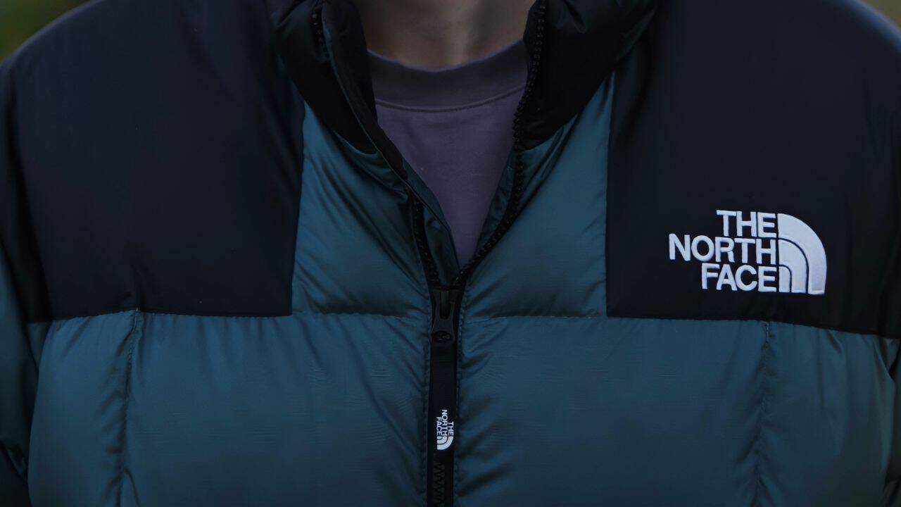 A closeup photo of a green and black North Face jacket 