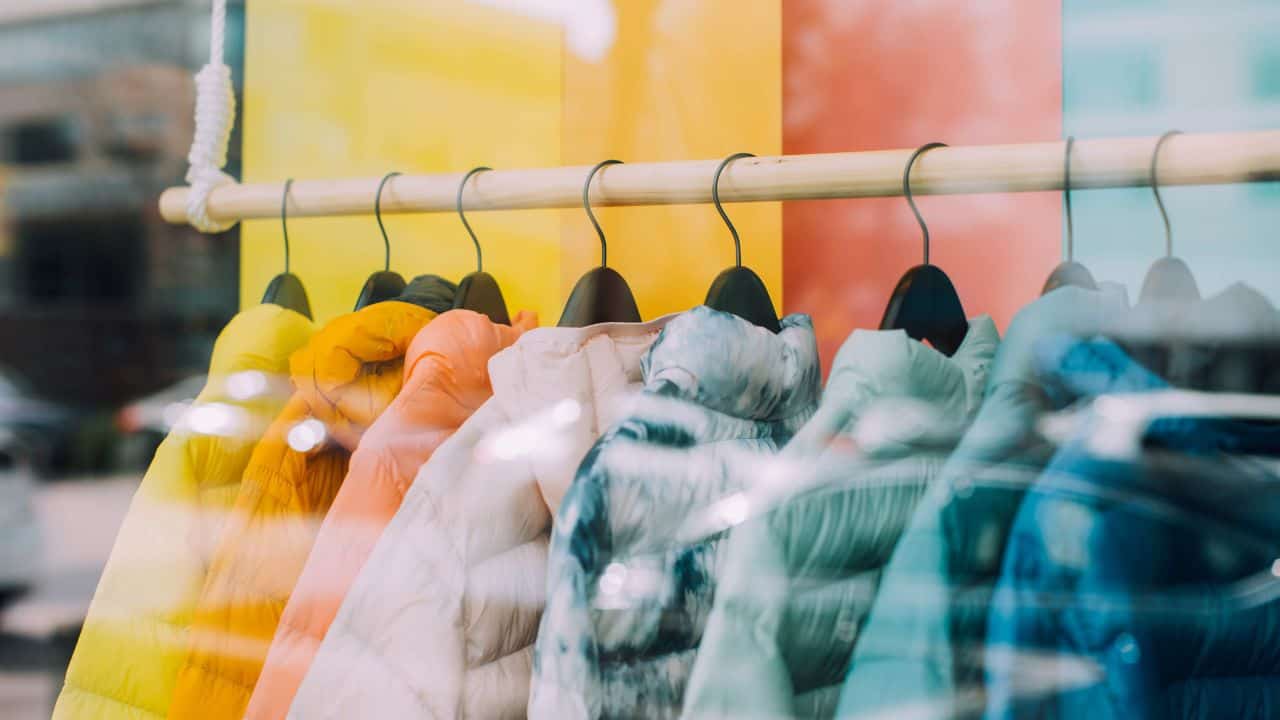 A collection of colourful jackets in a shop  