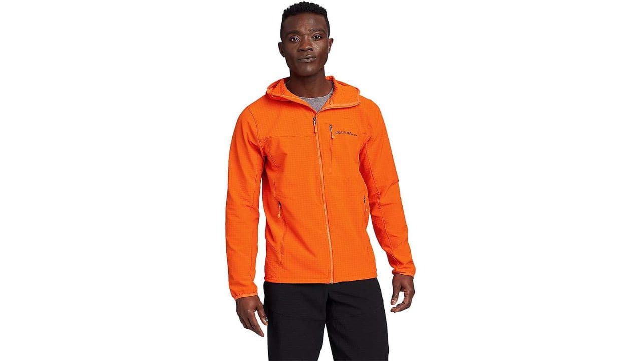 A man wearing a bright orange Eddie Bauer hooded jacket