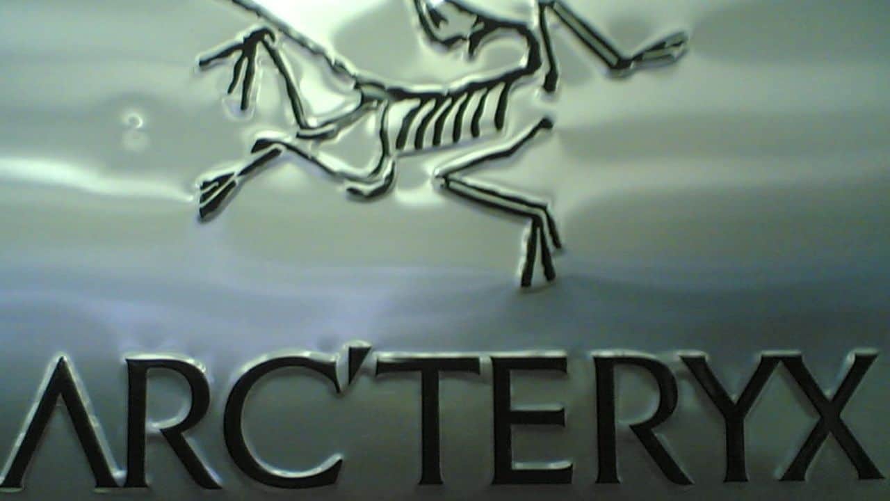 Closeup photo of a metallic Arc'teryx brand logo